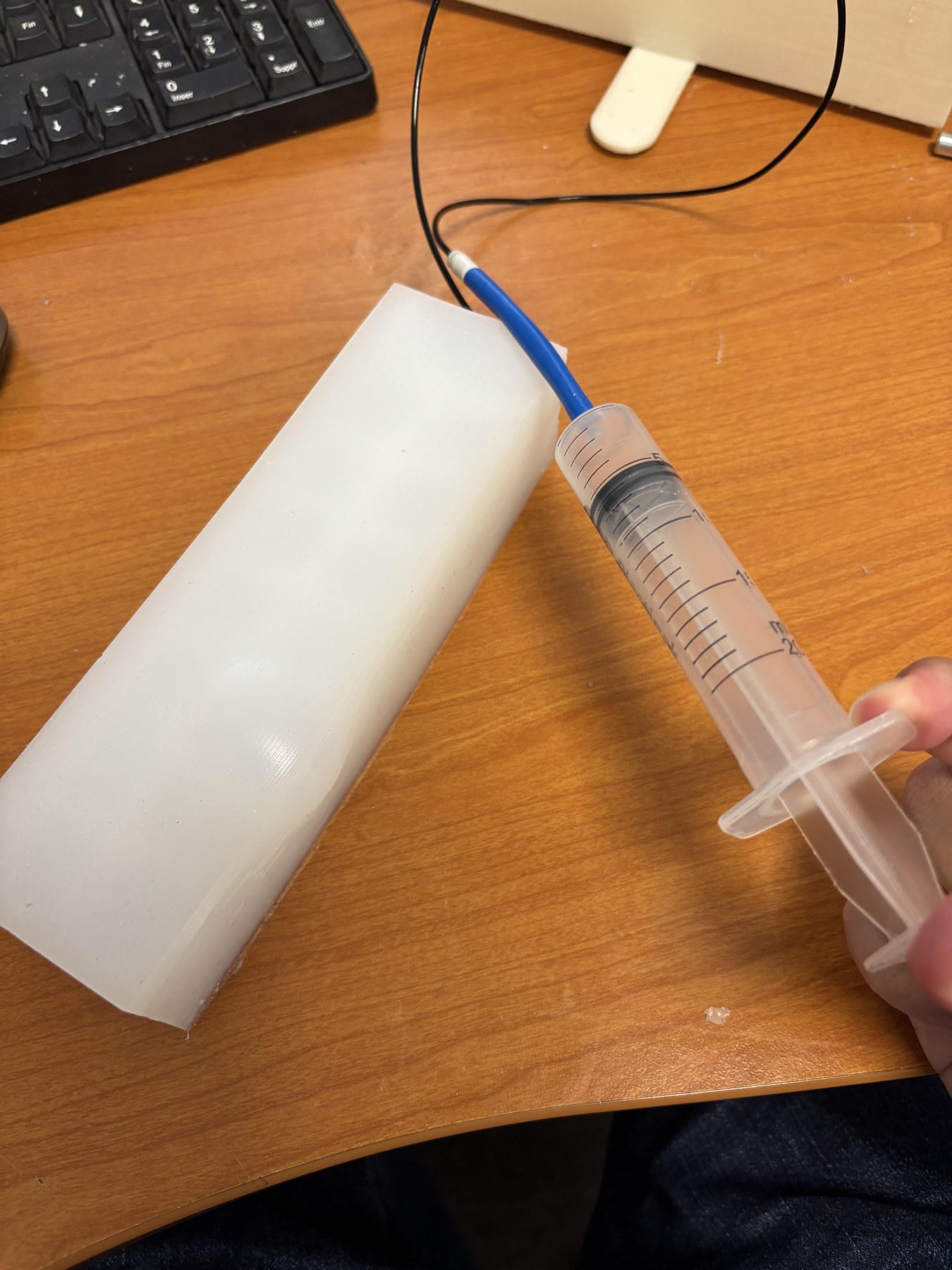 Hydrogel actuator connected to a syringe.